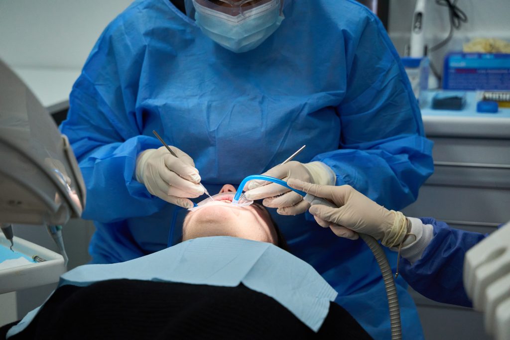 Dentist performing dental procedure on patient